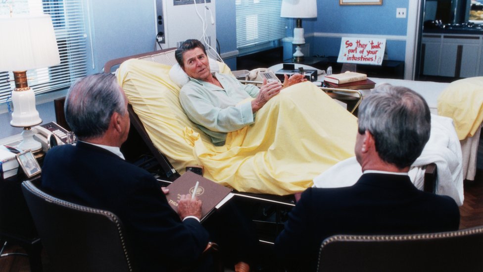 President Ronald Reagan holds a meeting with advisers while in the hospital for colon cancer surgery in 1985