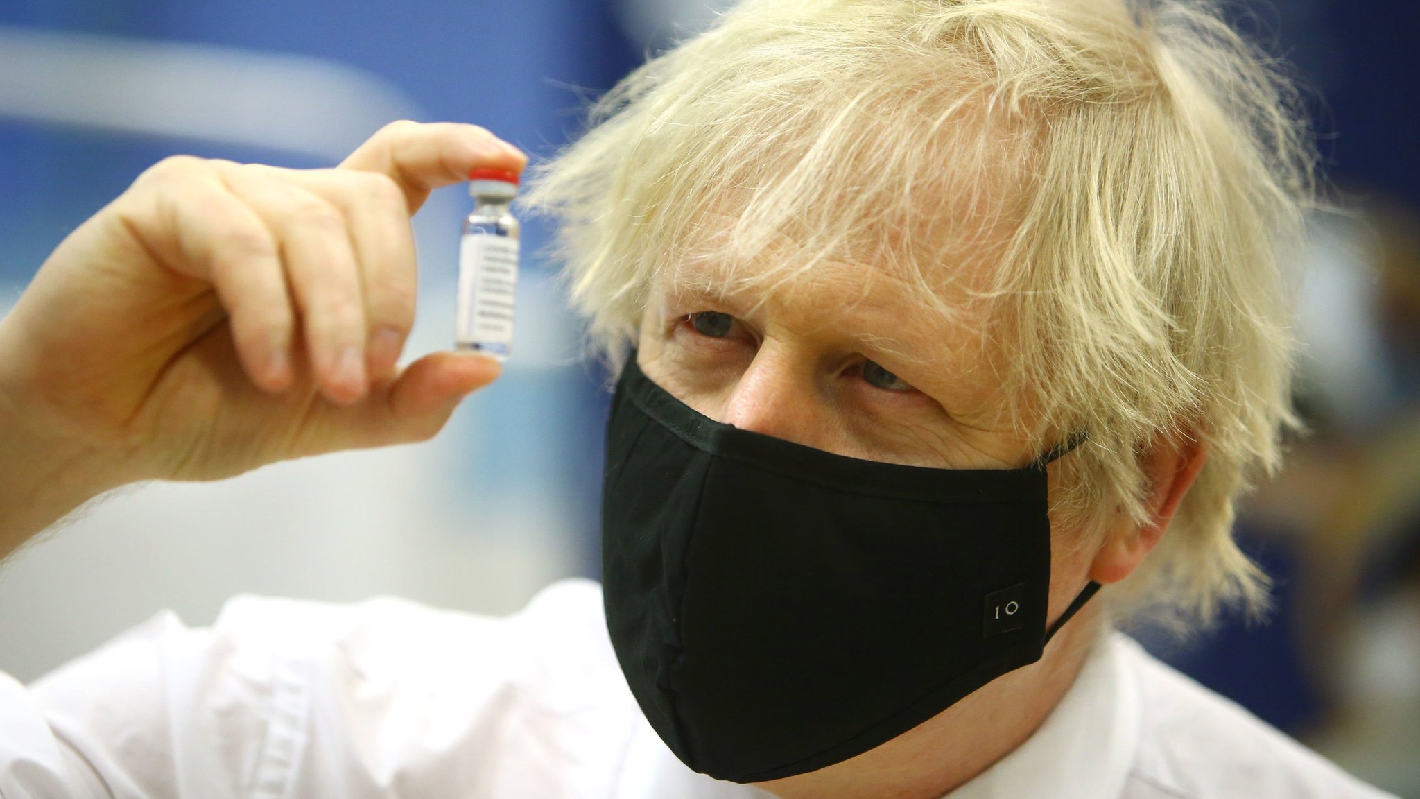Prime minister Boris Johnson holding a vial of the Oxford/Astra Zeneca Covid-19 vaccine as he visits a vaccination centre at Cwmbran Stadium in Cwmbran, south Wales