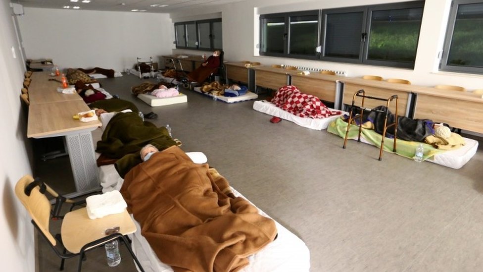 Displaced people sleep at a military base after an earthquake in Petrinja