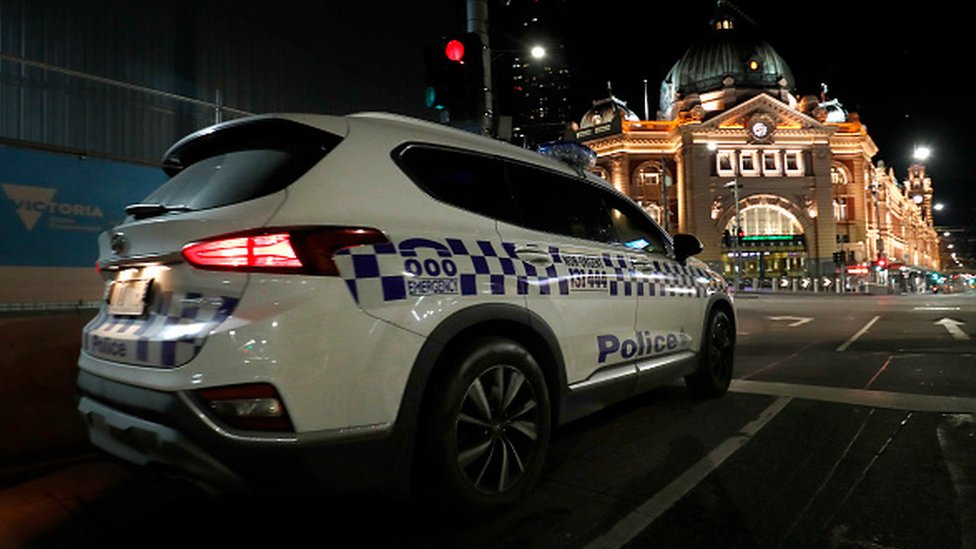A Victorian Police car patrols the streets in Melbourne, Australia
