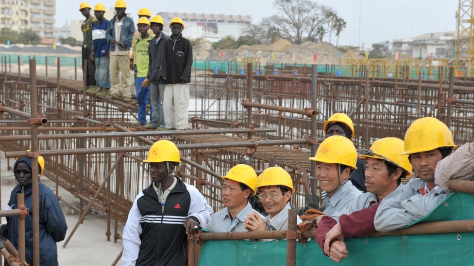 Chinese and Senegalese workers at the site of the half-built National Theatre in Senegal