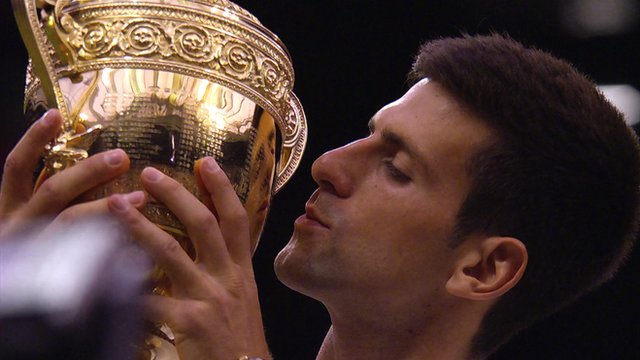 Novak Djokovic celebrates winning Wimbledon 2015 by kissing the trophy