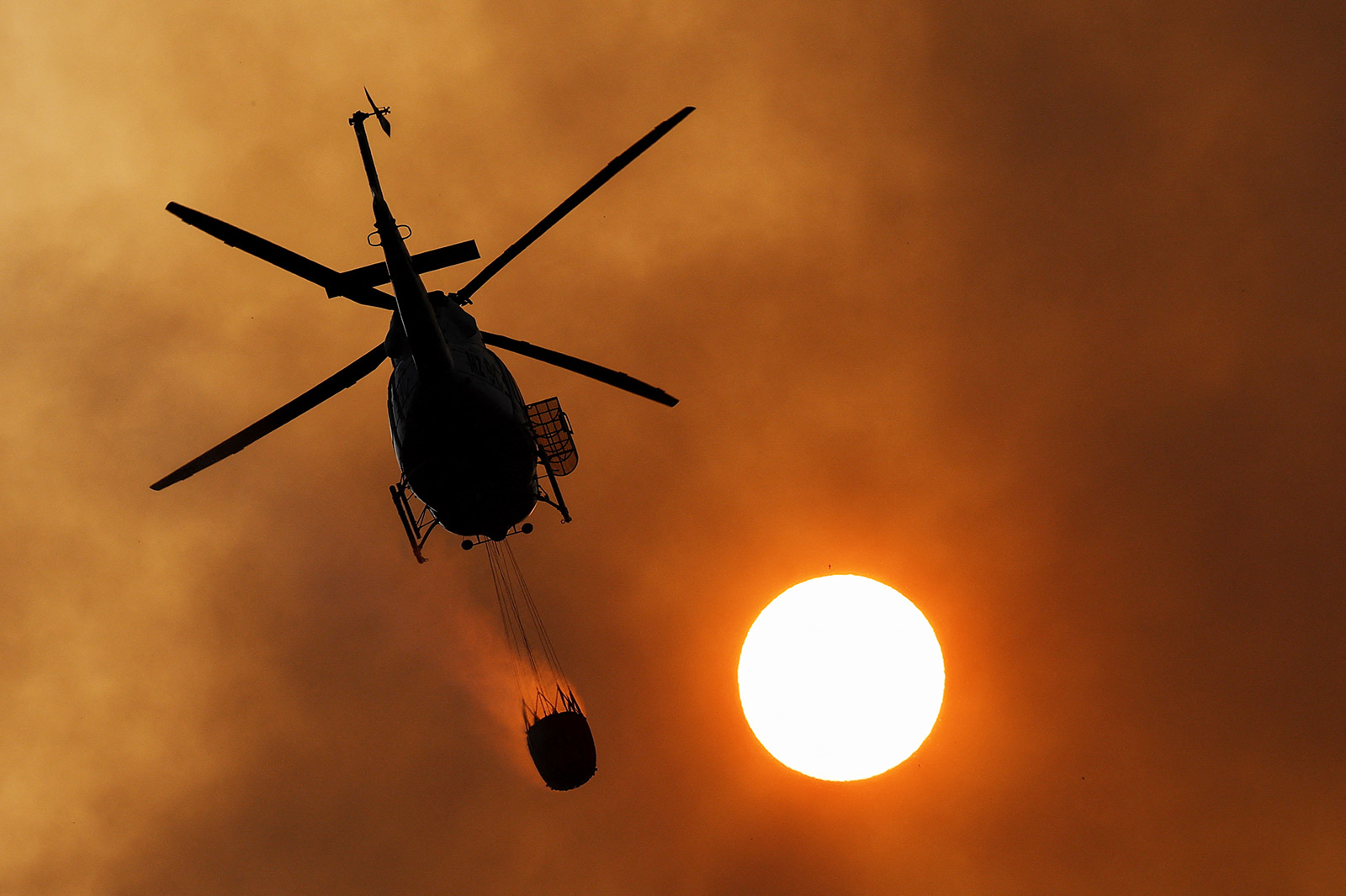 ​​A helicopter works to extinguish a wildfire, in the area of Pico de las Nieves, on the Canary Island of Gran Canaria - 25 July 2023