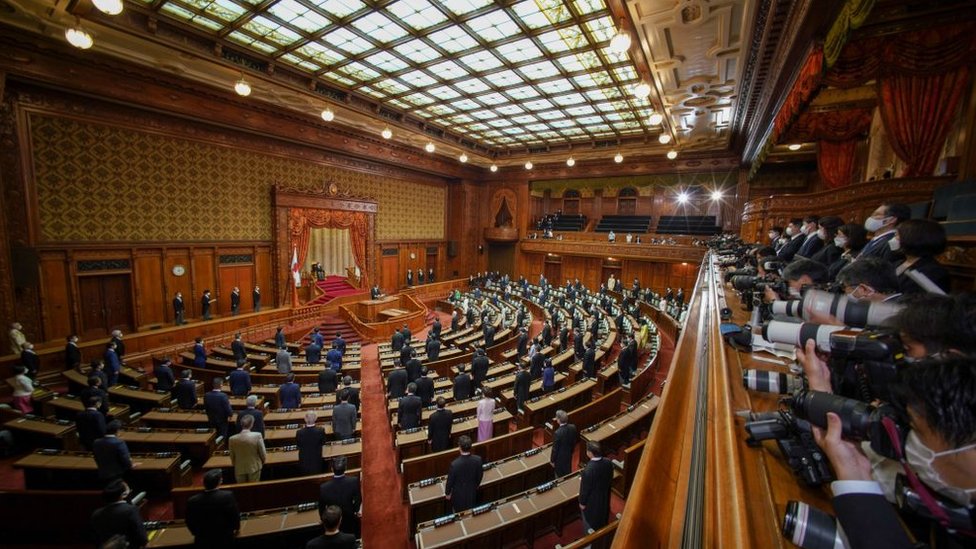 Photographers take pictures of the session hall of Japan's parliament.