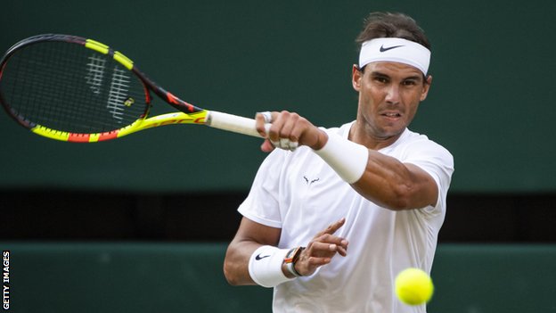 Rafael Nadal hits a return at Wimbledon in 2019