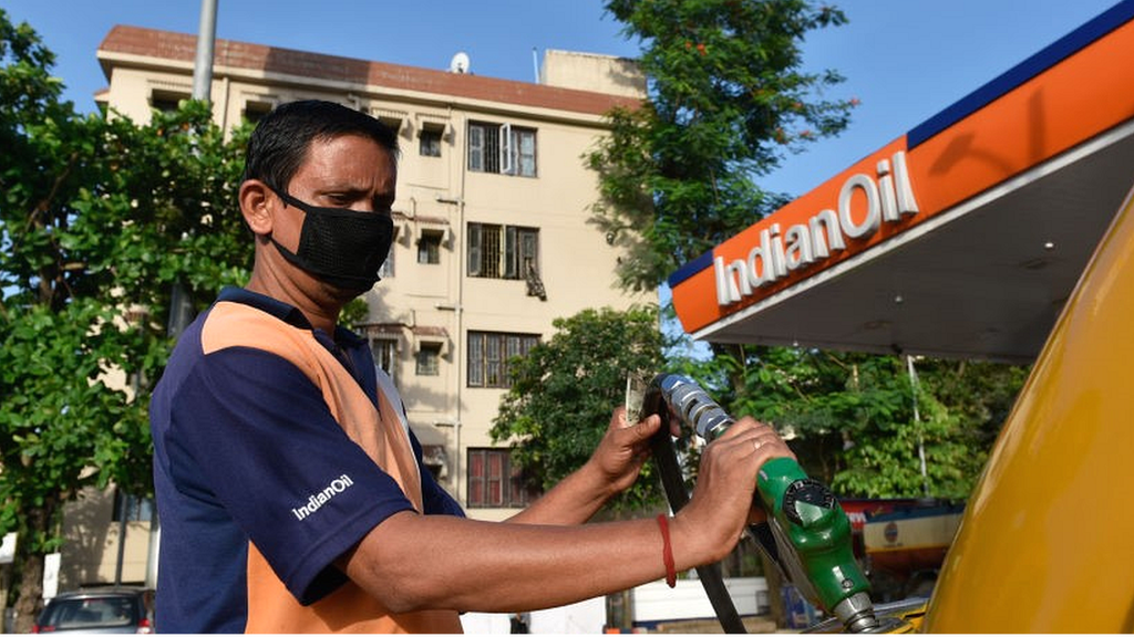 Man at petrol station filling vehicle