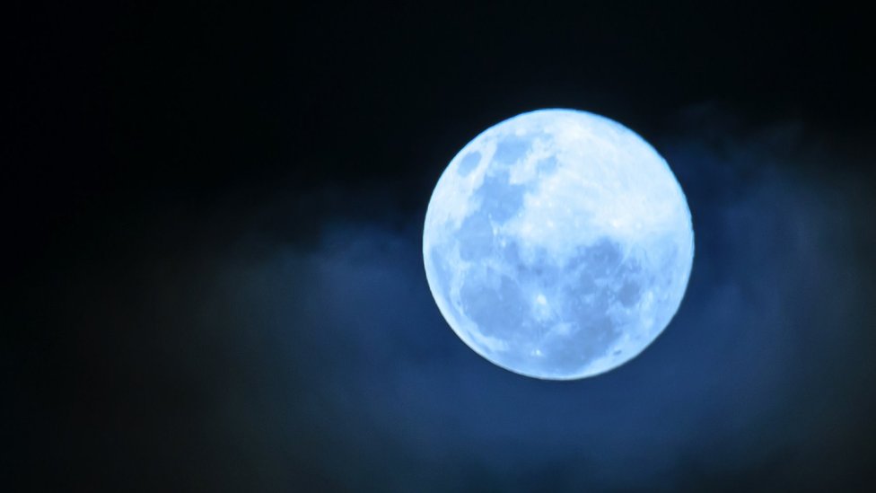 Close up of a full moon with a blue tinge