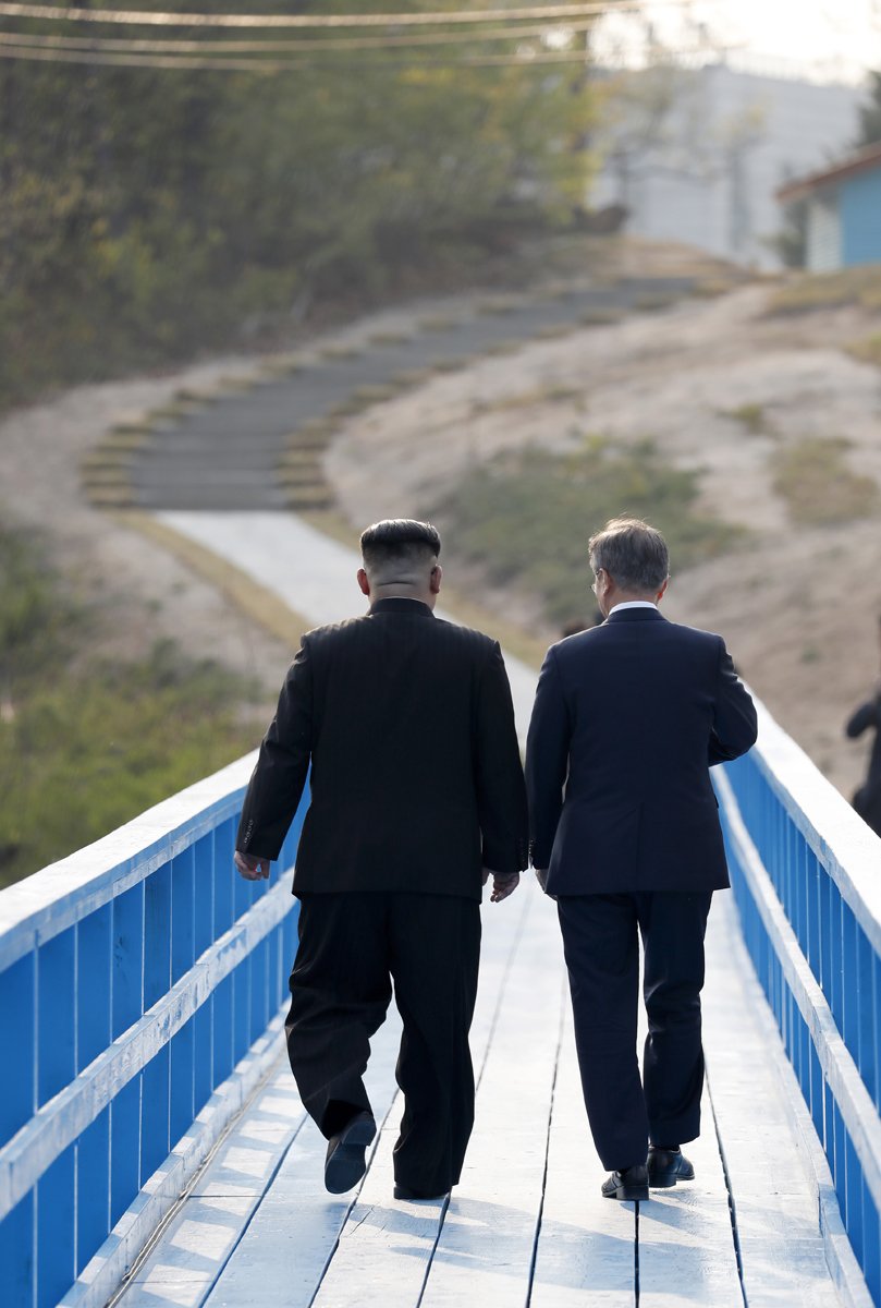 North Korean leader Kim Jong Un (L) and South Korean President Moon Jae-in (R) take a walk on the walk bridge during the Inter-Korean Summit on April 27, 2018 in Panmunjom, South Korea. Kim and Moon meet at the border today for the third-ever Inter-Korean summit talks after the 1945 division of the peninsula, and first since 2007 between then President Roh Moo-hyun of South Korea and Leader Kim Jong-il of North Korea. (Photo by Korea Summit Press Pool/Getty Images)