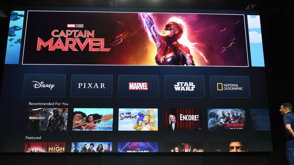 A giant screen shows Marvel's Captain Marvel being promoted on the home screen of the Disney+ app