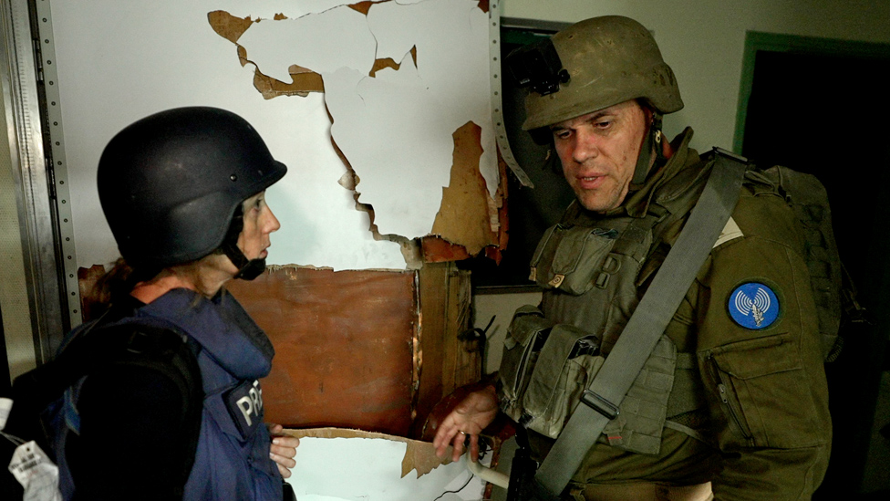 Lt Col Jonathan Conricus of the Israel Defense Forces (R) talks to BBC correspondent Lucy Williamson (L) a shelf inside Al-Shifa Hospital, in Gaza City (15 November 2023)