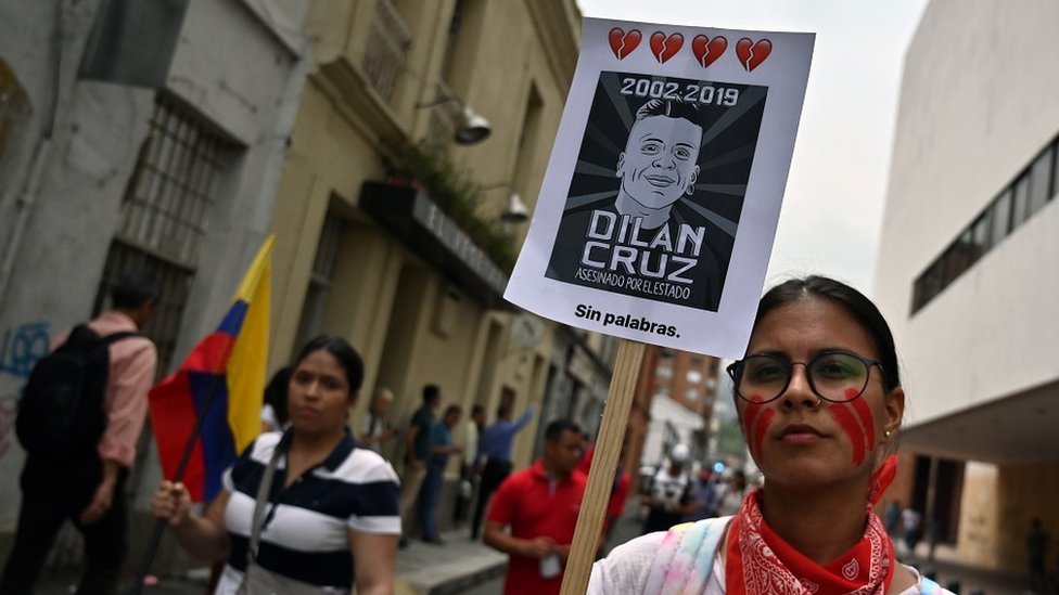 A demonstrator holds a poster of the late student Dilan Cruz - who died due to injuries from a police shot on November 23 - during a march against the government of Colombian President Ivan Duque during a national strike, in Cali on November 27, 2019.