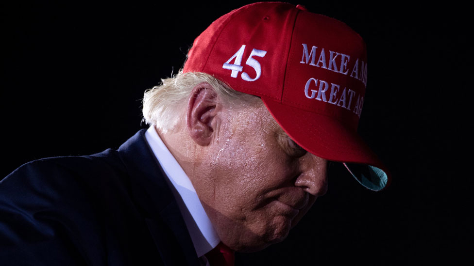 Donald Trump de perfil con una gorra roja