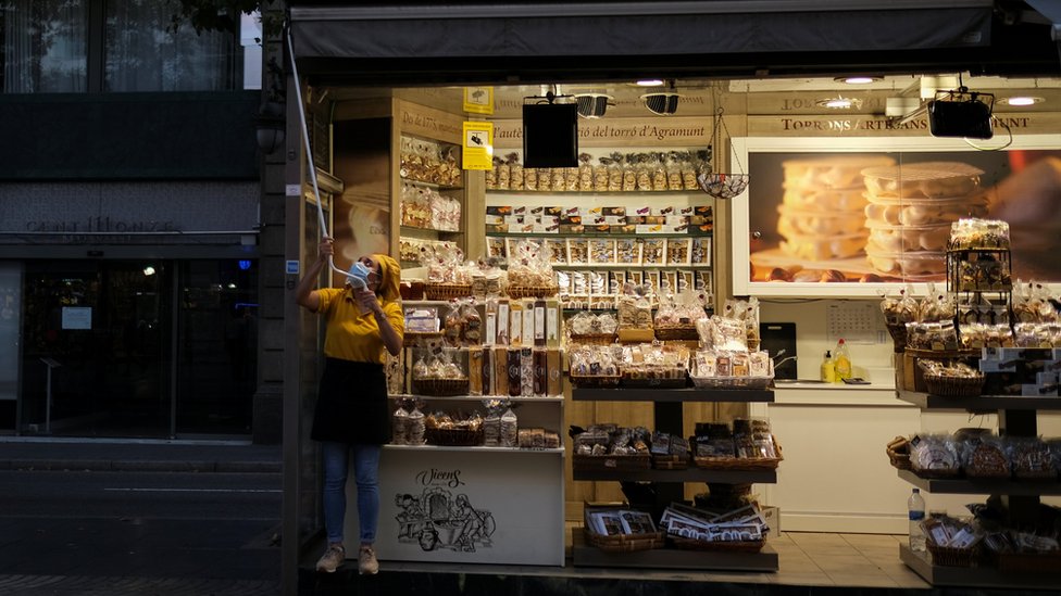 Shopkeeper closing up in La Rambla, Barcelona