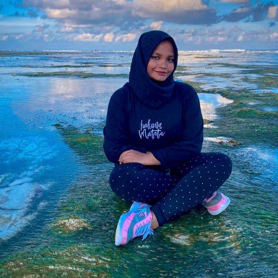 Ameera Latheef sits by the sea