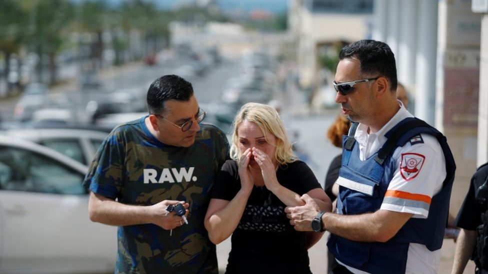 Woman comforted after rocket attack in Ashkelon