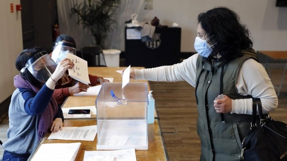 A woman casts her ballot at a polling station in Barcelona. Photo: 14 February 2021