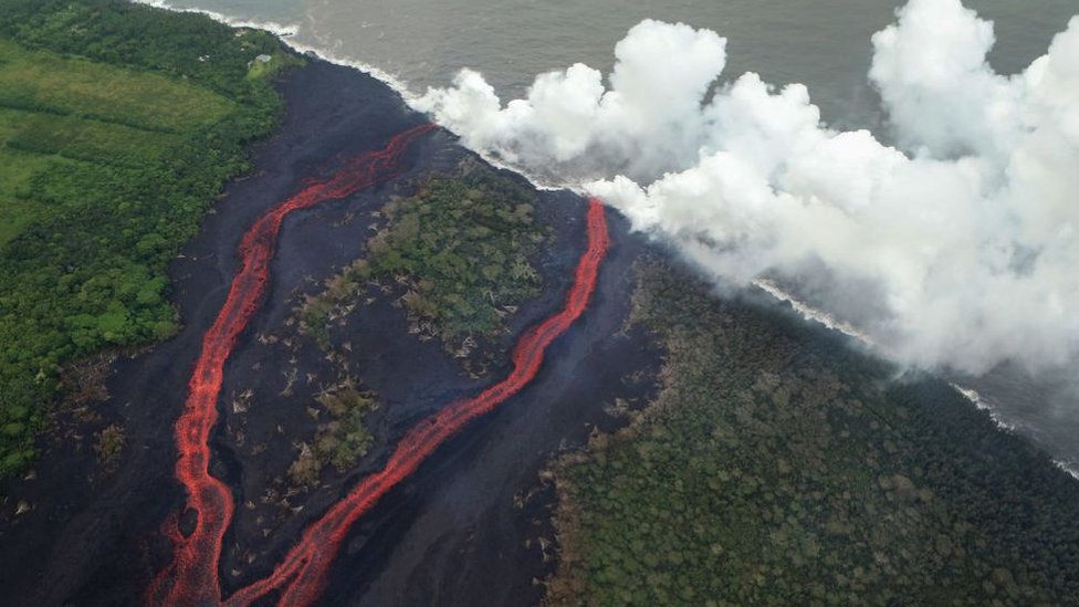 Steam plumes rise as lava enters the Pacific Ocean, after flowing to the water from a Kilauea volcano fissure, on Hawaii`s Big Island on May 21, 2018 near Pahoa, Hawaii.