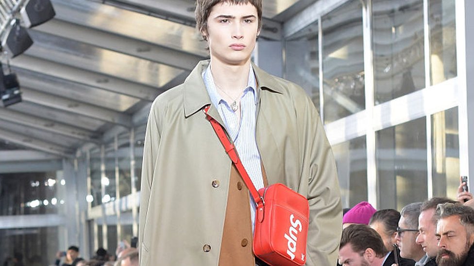 men wearing tote bags