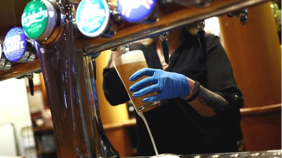 Pub worker pulling a pint