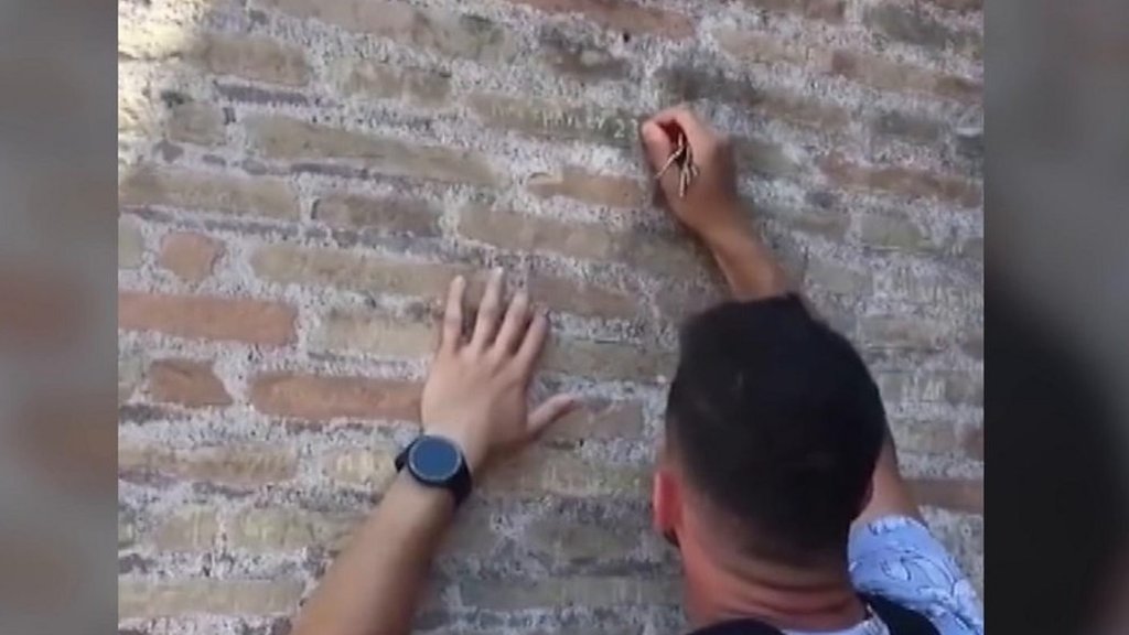 Police hunt man filmed carving names on Colosseum