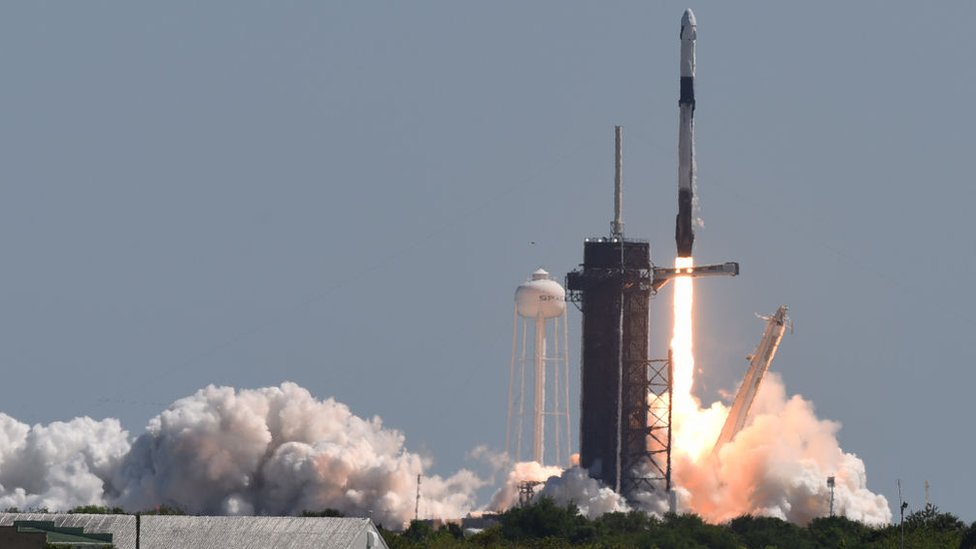 A SpaceX Falcon 9 rocket with a Crew Dragon spacecraft and four private astronauts launches