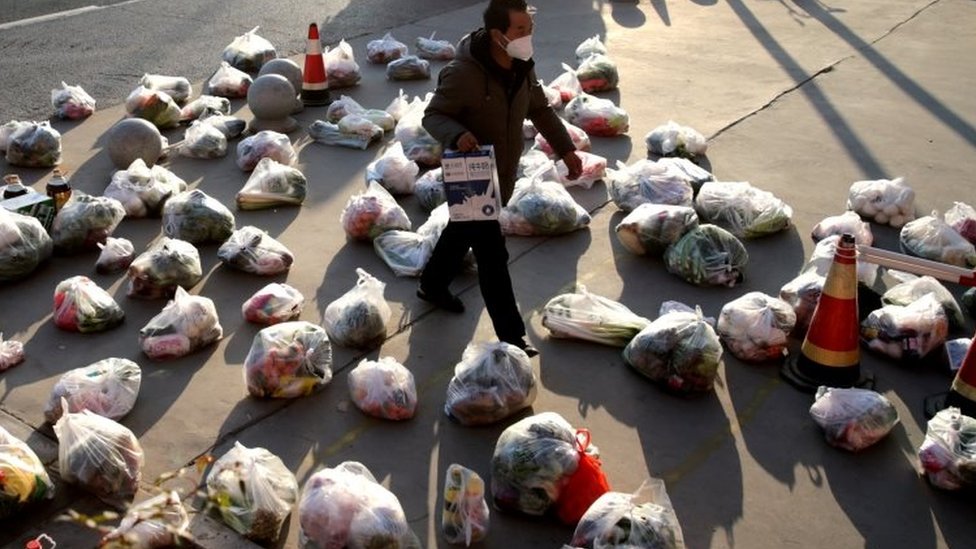 A worker prepares to ship out food supplies to people in Xi'an