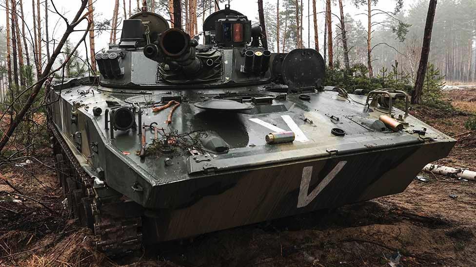 A Russian armoured vehicle in woodland with a 
