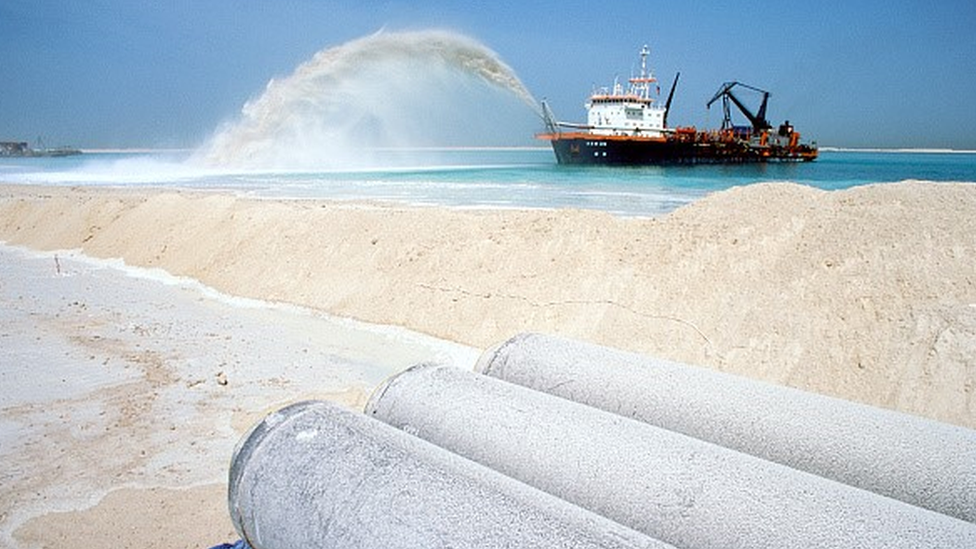 A dredger pumps sand onto an artificial island in Dubai, UAE