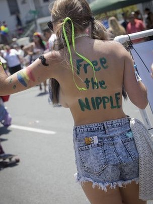 Young women demanding to go topless with the slogan "Free the nipple" on her back