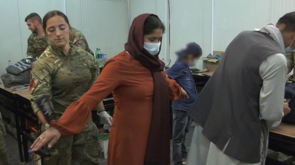 Afghans being taken onto UK flight at Kabul airport