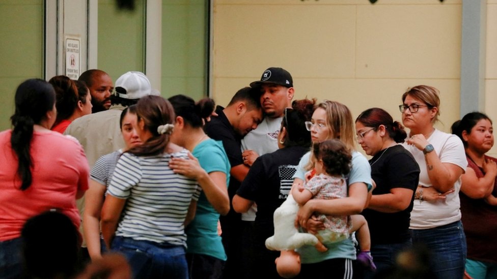 People wait outside the SSGT Willie de Leon Civic Center where students had been transported from Robb Elementary School after the shooting in Uvalde, Texas