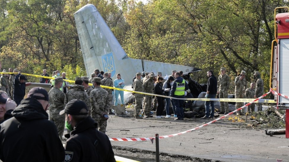 Rescuers inspect the crash site of the An-26 plane near Kharkiv, Ukraine, on 26 September 2020