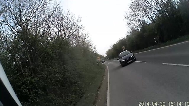Cyclist helmet camera footage of the car swerving
