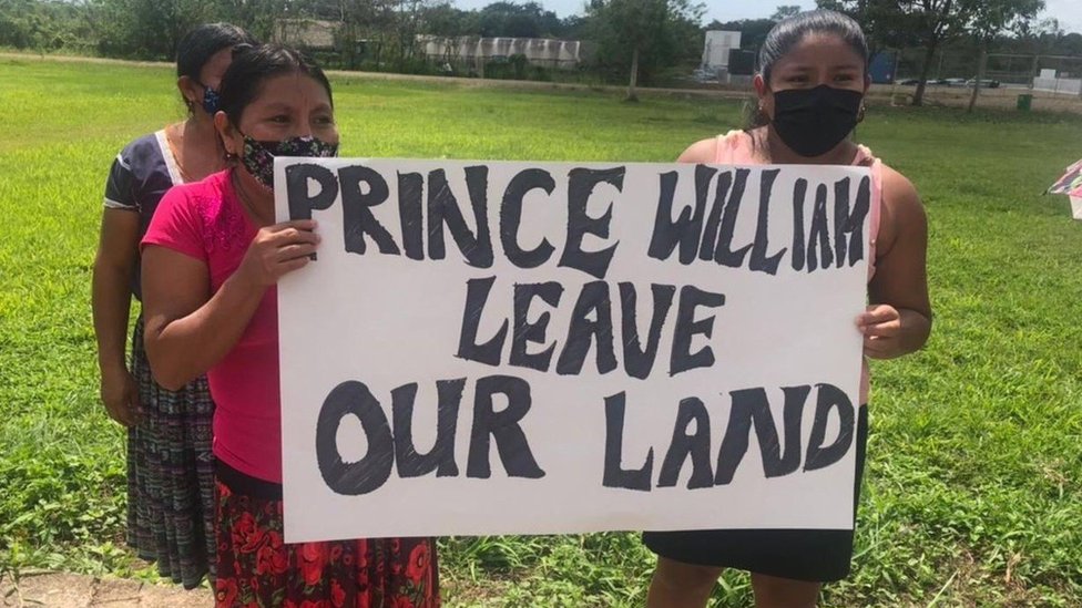 Protesters in Indian Creek, Belize, holding a sign that reads 'Prince William leave our land'