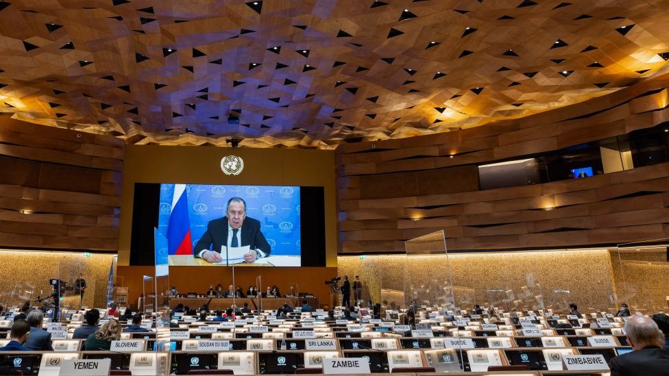 Russia's foreign minister Sergei Lavrov (on screen) addresses with a pre-recorded video message at the 49th session of the UN Human Rights Council at the European headquarters of the United Nations in Geneva, Switzerland