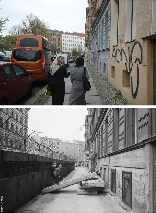 Two women walk along Sebastianstrasse, along which the Berlin Wall once ran, on October 2019. The photo underneath shows the same location in 1963