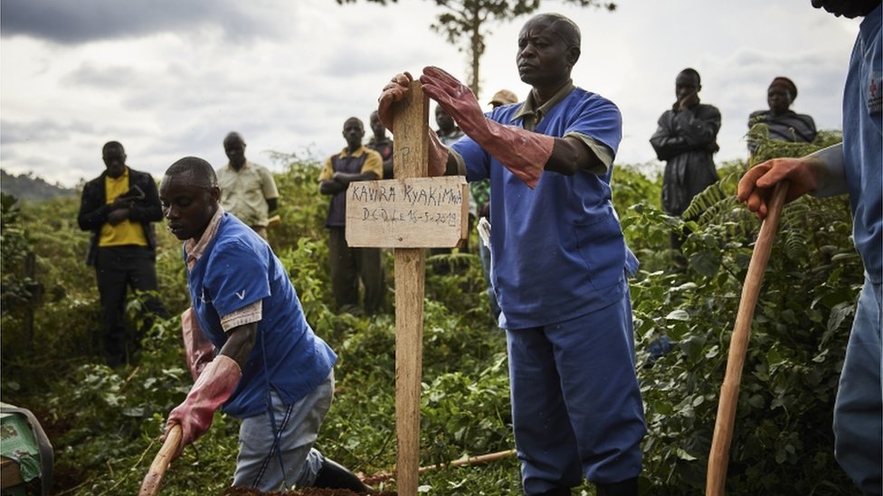 Health workers take part in the funeral of Ebola victims at Kitatumba cemetery in Butembo, North Kivu province