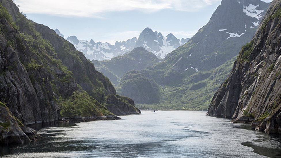 Steep sided glacial trough fiord jagged mountain peaks, Trollfjorden, Lofoten Islands, Nordland, northern, Norway