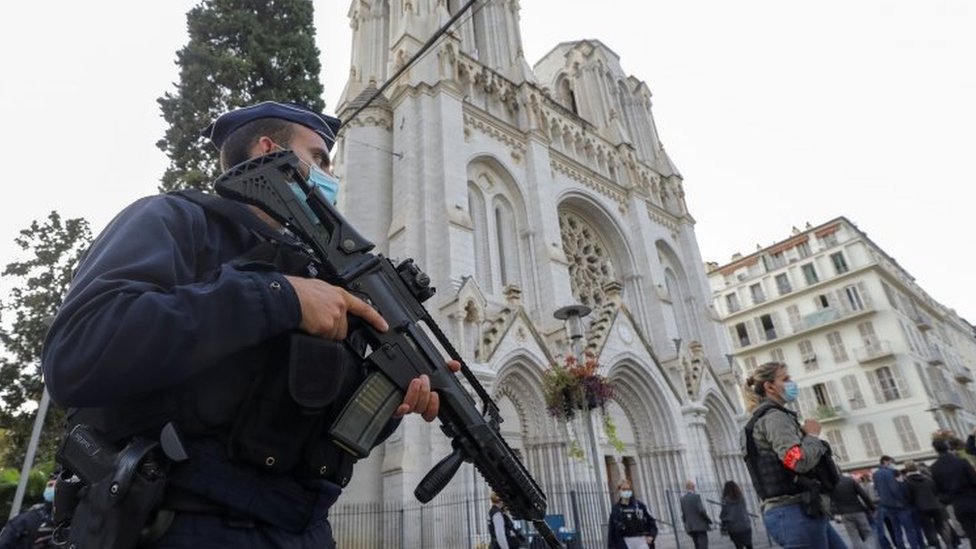 Police officers stand outside the Notre Dame church in Nice