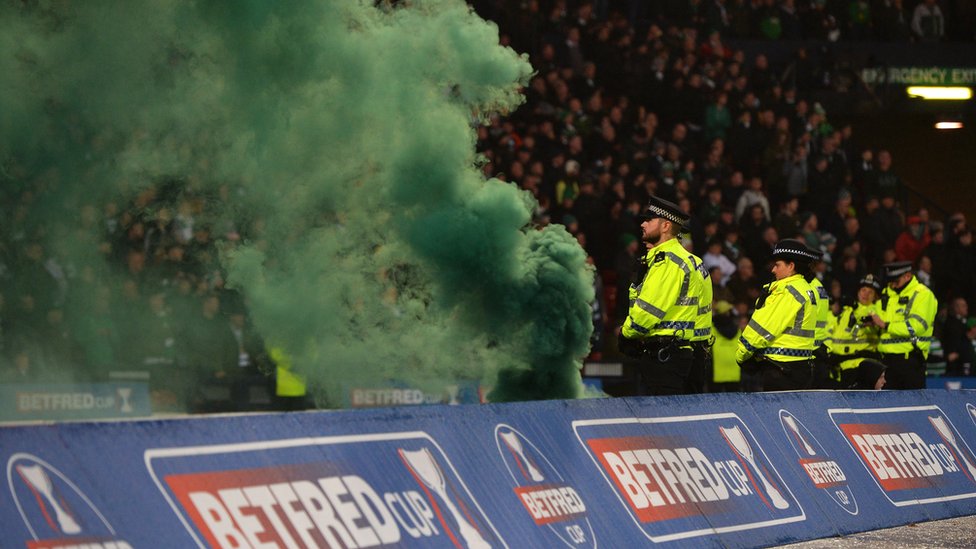 Вспышка зеленого дыма выбрасывается за пределы поля во время финала Кубка Бетфреда между «Селтик» и «Абердин» в Хэмпден-парке 2 декабря 2018 г.