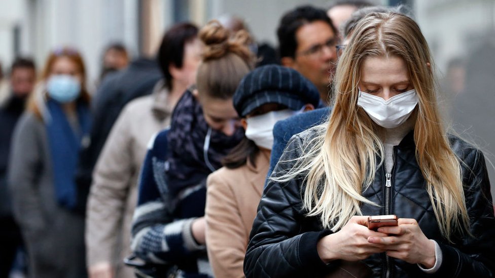 Pessoas jovens em fila de supermercadoe m Paris