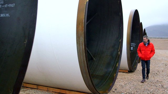 Spencer Kelly stands next to Hyperloop tubes