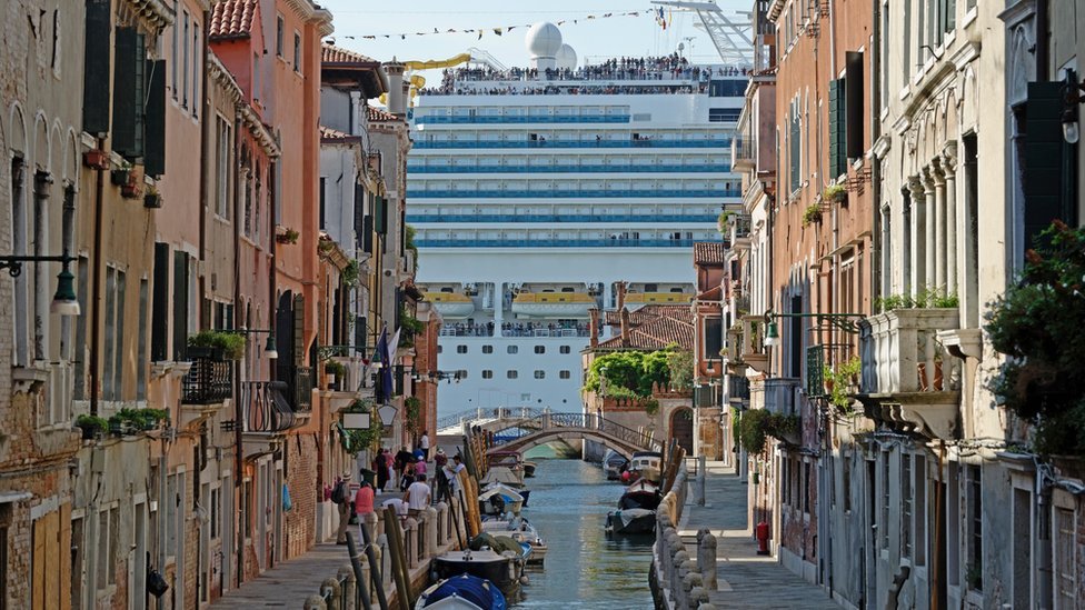 威尼斯一條狹窄的運河盡頭可見一艘大型遊輪