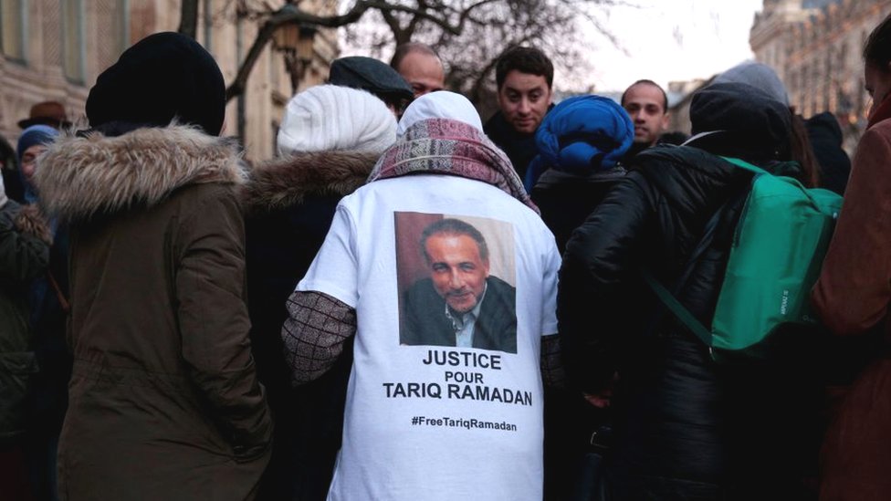A protester wears a shirt reading 