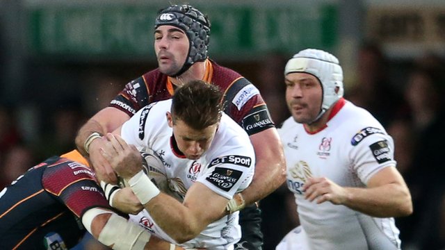Craig Gilroy attempts to go on a charge for Ulster with Rory Best in close attendance