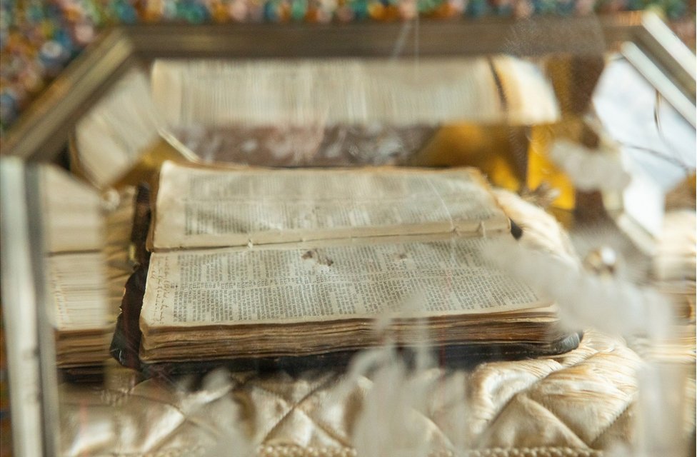 A Bible placed inside the casket of an organ clock