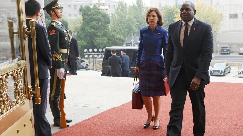 Britain's Foreign Secretary David Lammy (R) and British Ambassador to China Caroline Wilson (2-R) arrive at the Great Hall of the People in Beijing, China, 18 October 2024.