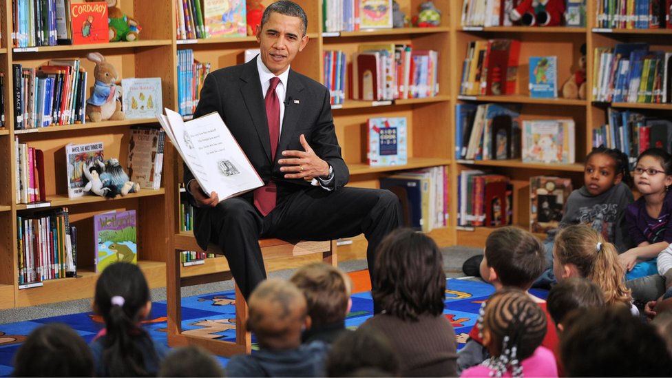 US President Barack Obama reads books, including his book 'Of Thee I Sing' to 2nd graders at Long Branch Elementary School in Arlington, Virginia, on 17 December 2010