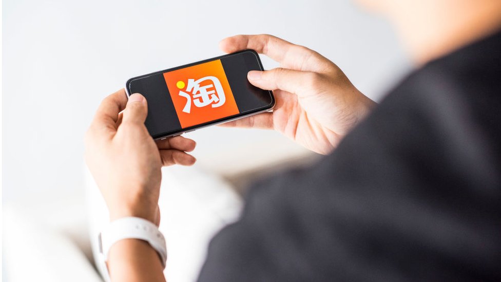 Man using Taobao app on Apple iPhone