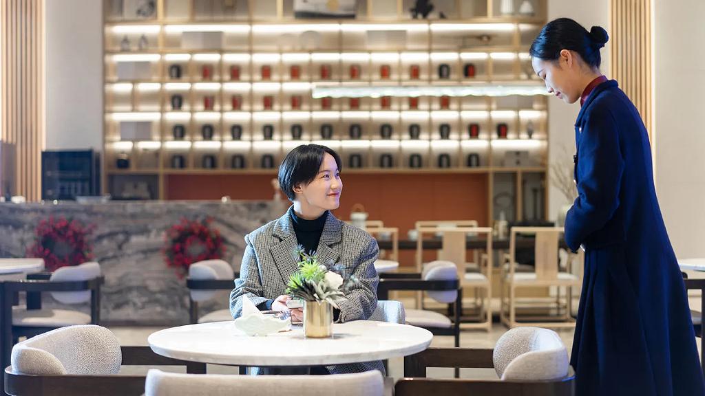 Customer and waitress in restaurant in China